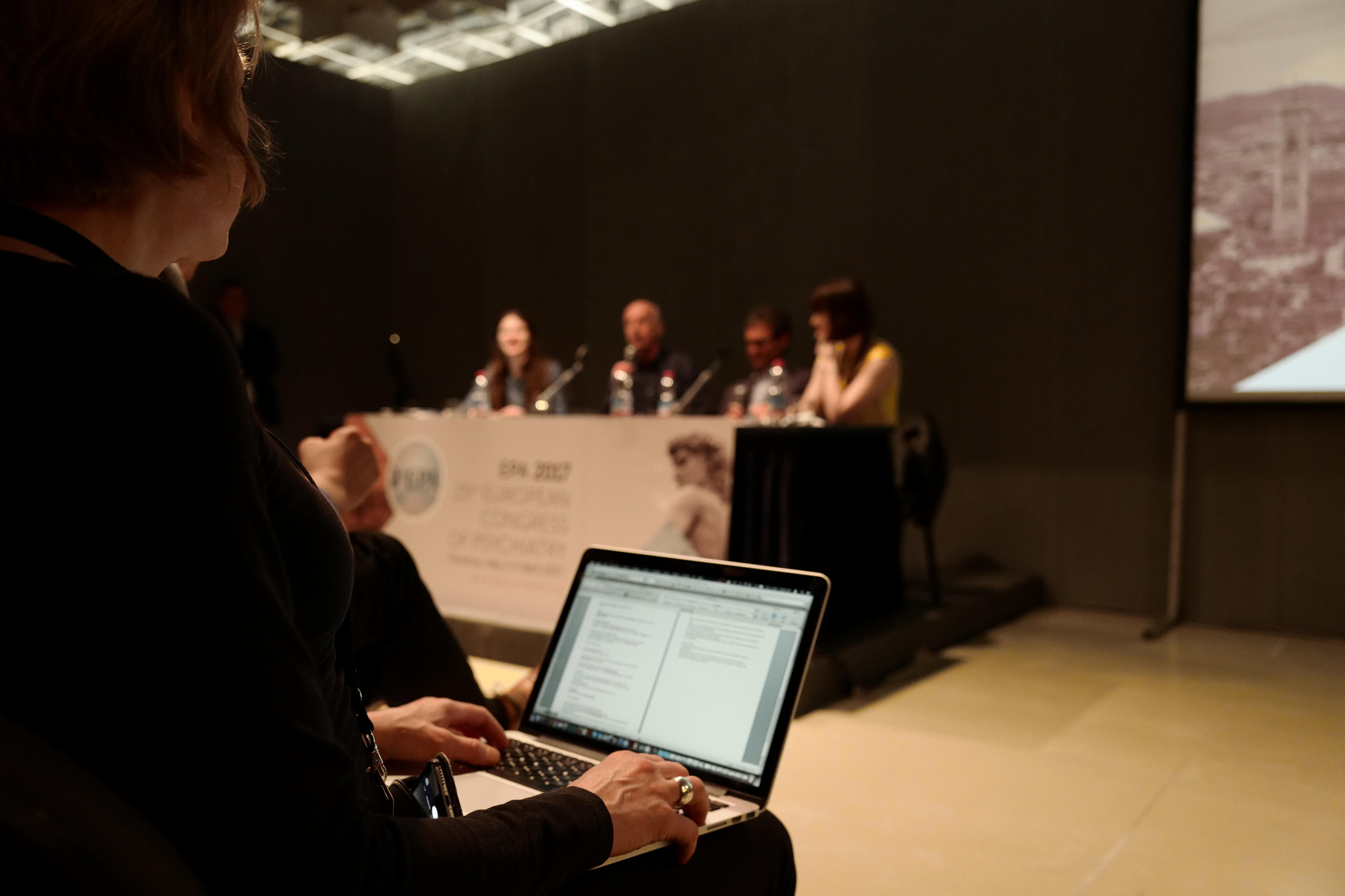 Spectator takes notes of the conference