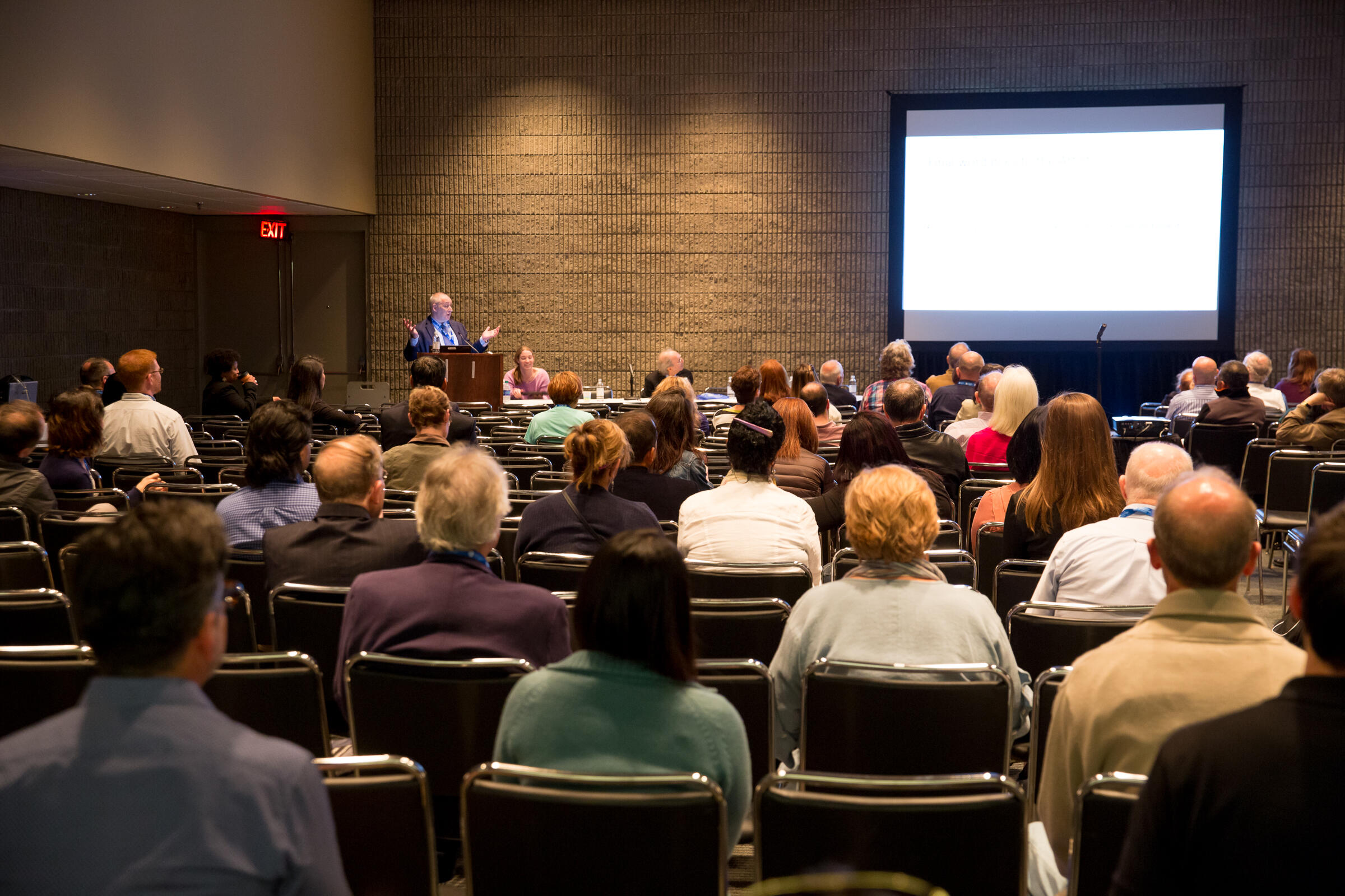 Room full of viewers of a presentation about schizophrenia.